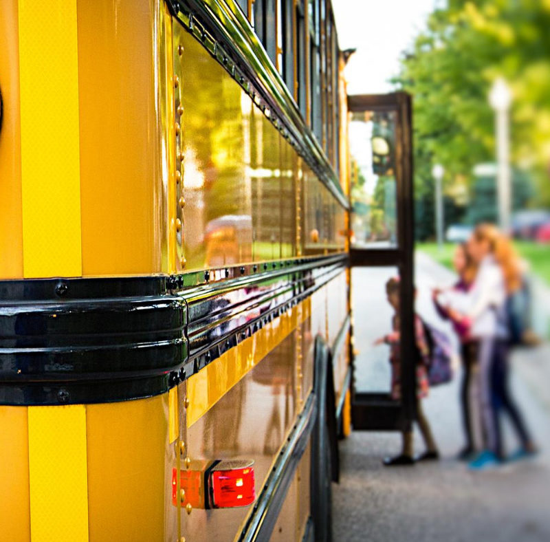 Students getting on a school bus