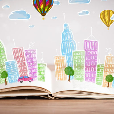 Book laying open with graphic representation of city building bursting from the pages