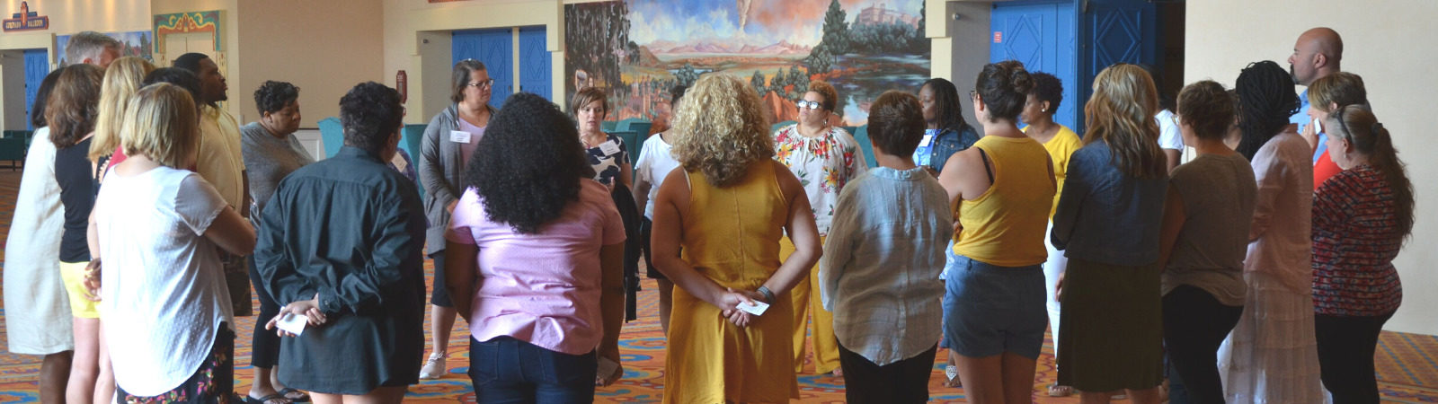 Educators gathered in a circle during a Pegasus Springs Education Collective event