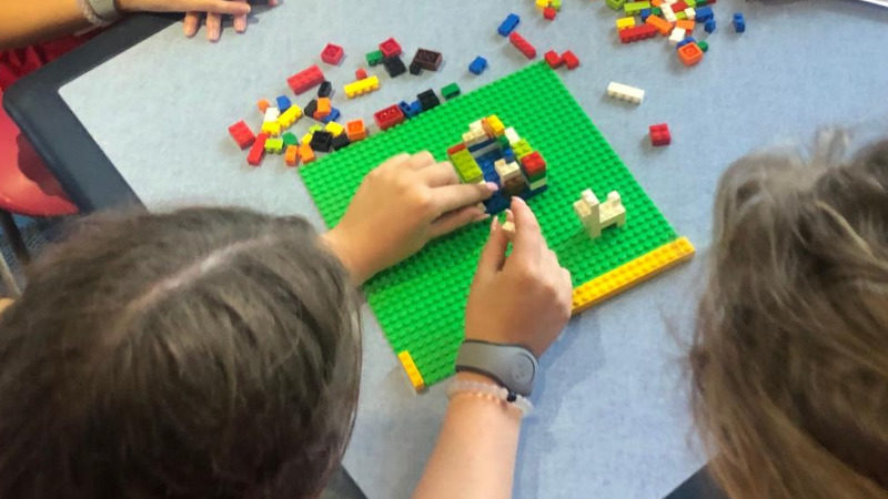 Students in Pegasus Springs Education Collective's BOLT program for student voice doing a learning exercise with LEGOS