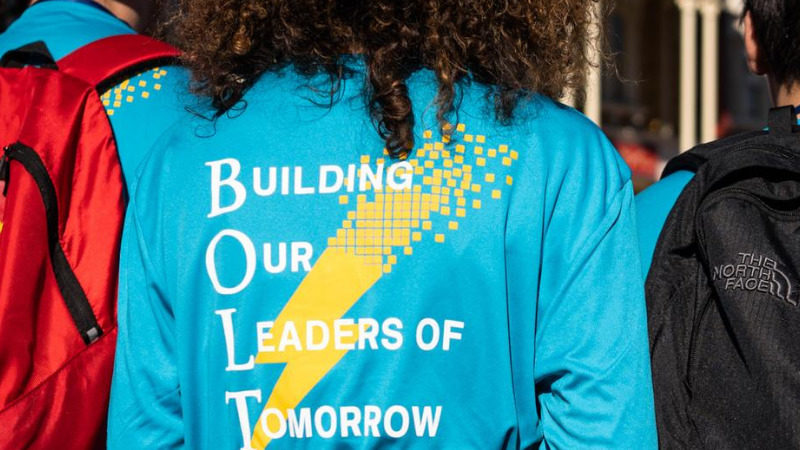 Back of student's shirt featuring BOLT program text "building our leaders of tomorrow"